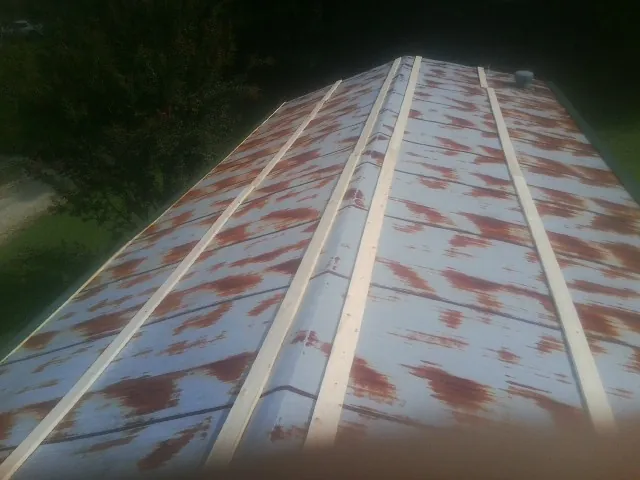 Rusted metal roof panels with new wood purlins before replacement — Storm Damage Roof Repair in Old Monroe by Roofing Brothers